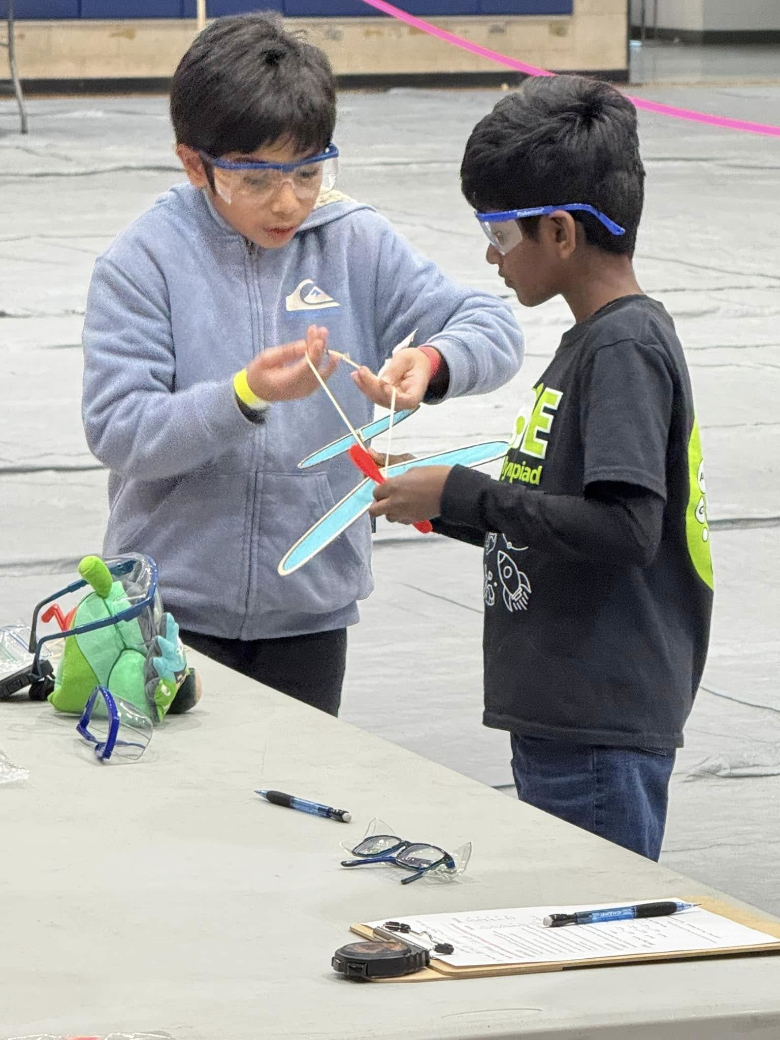  students assembling a rocket